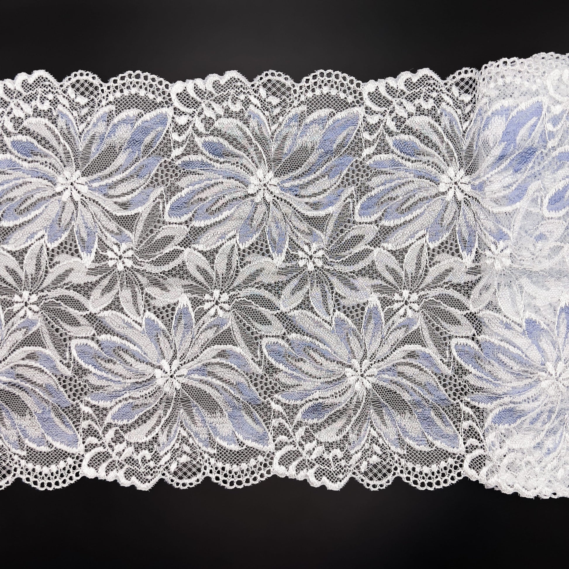 Silver and light blue elastic lace fabric, 22 cm wide, featuring a floral design, perfect for sewing sophisticated intimate apparel.