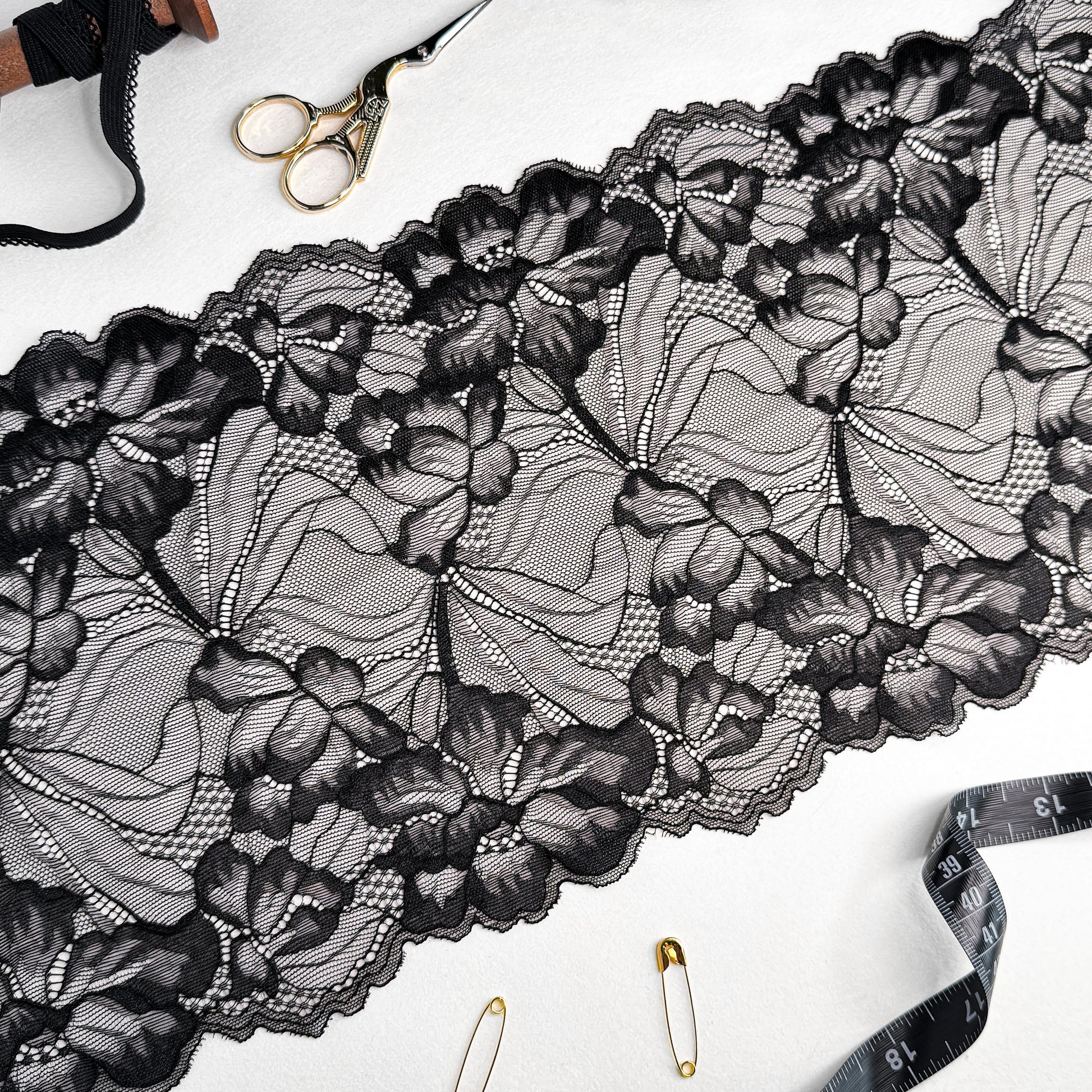 Black elastic lace trim, 21cm wide, featuring elegant floral patterns, perfect for luxury lingerie sewing projects.