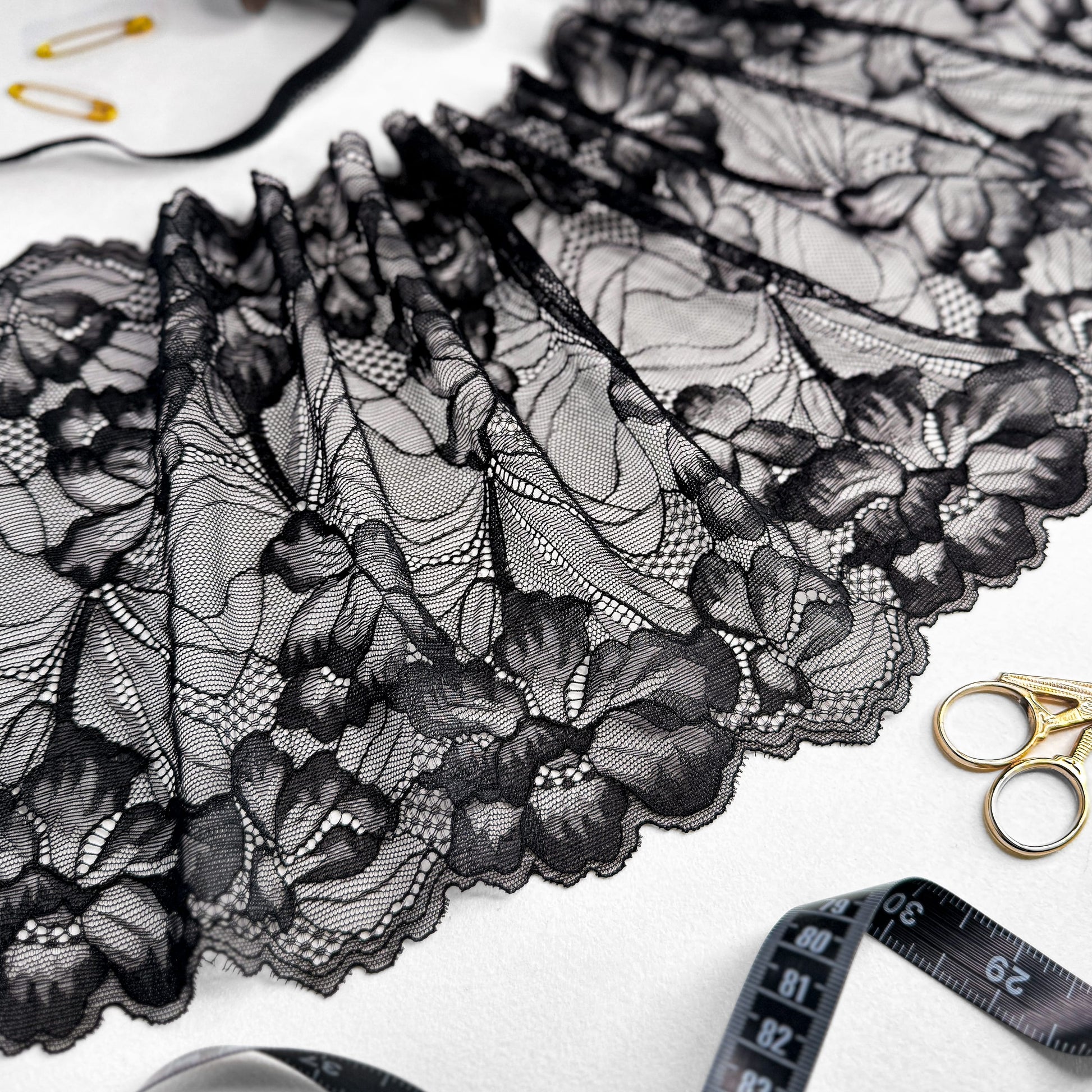 Delicate black stretch lace with intricate floral designs, ideal for creating handmade bras, panties, and bralettes.