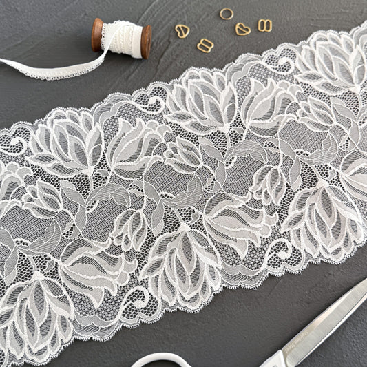 White elastic lace trim, 20cm wide, featuring elegant floral patterns, ideal for bridal lingerie and luxury sewing projects.