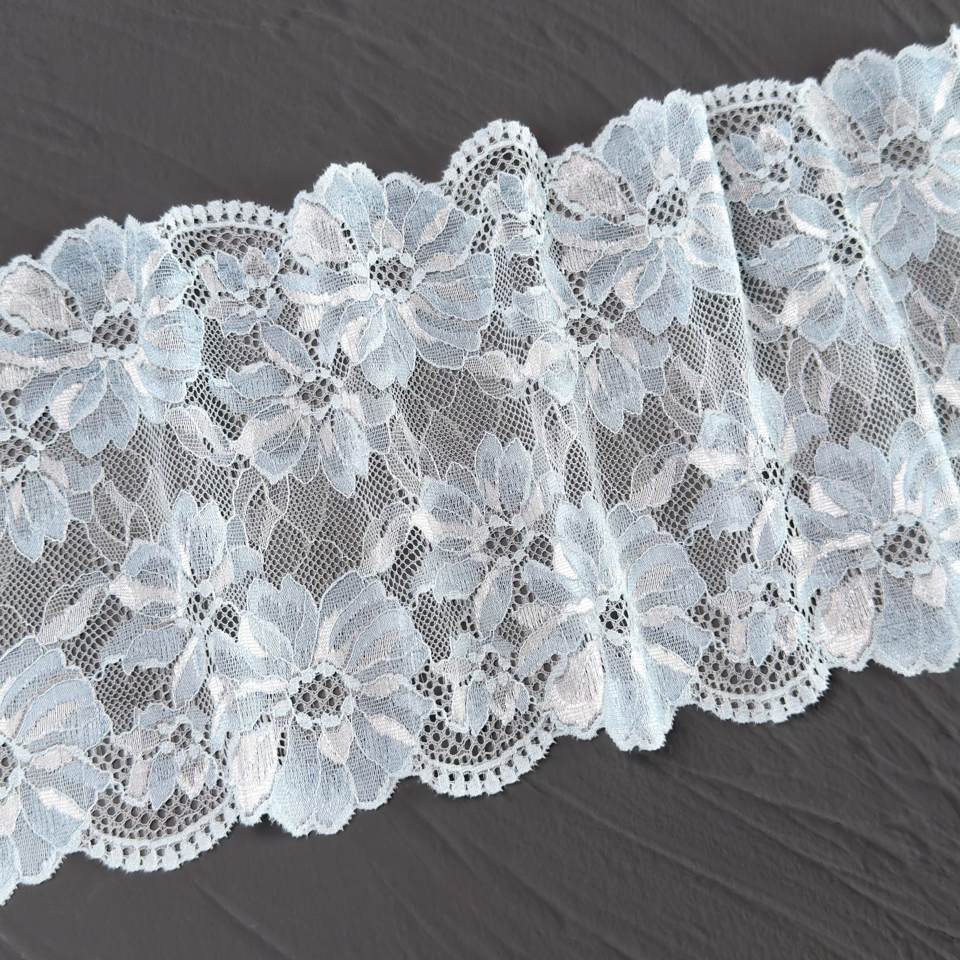 Elastic lace 17cm wide in light blue, featuring a floral pattern, ideal for lingerie sewing projects.