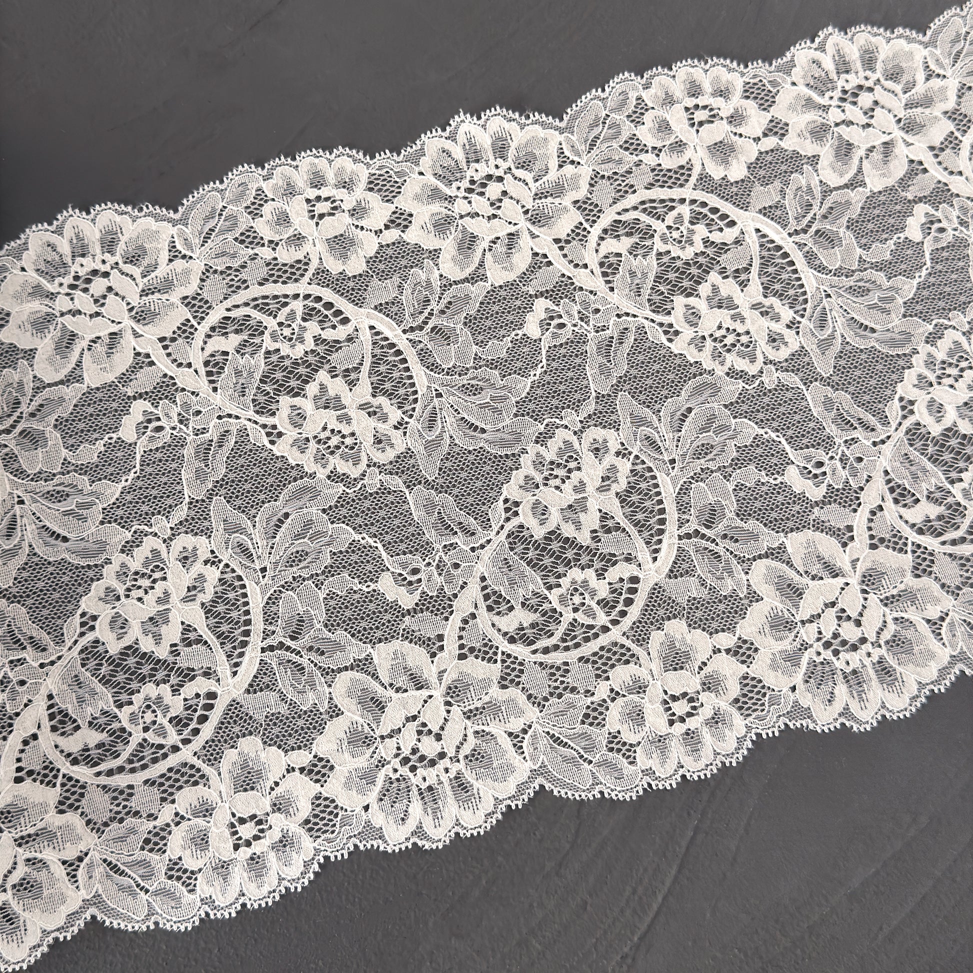 Close-up of white lace fabric on a dark background