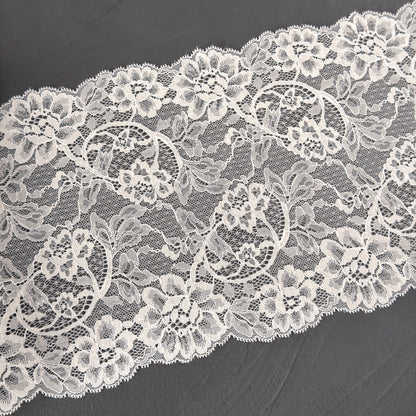 Close-up of white lace fabric on a dark background