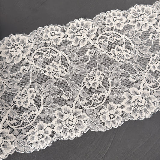 Close-up of white lace fabric on a dark background