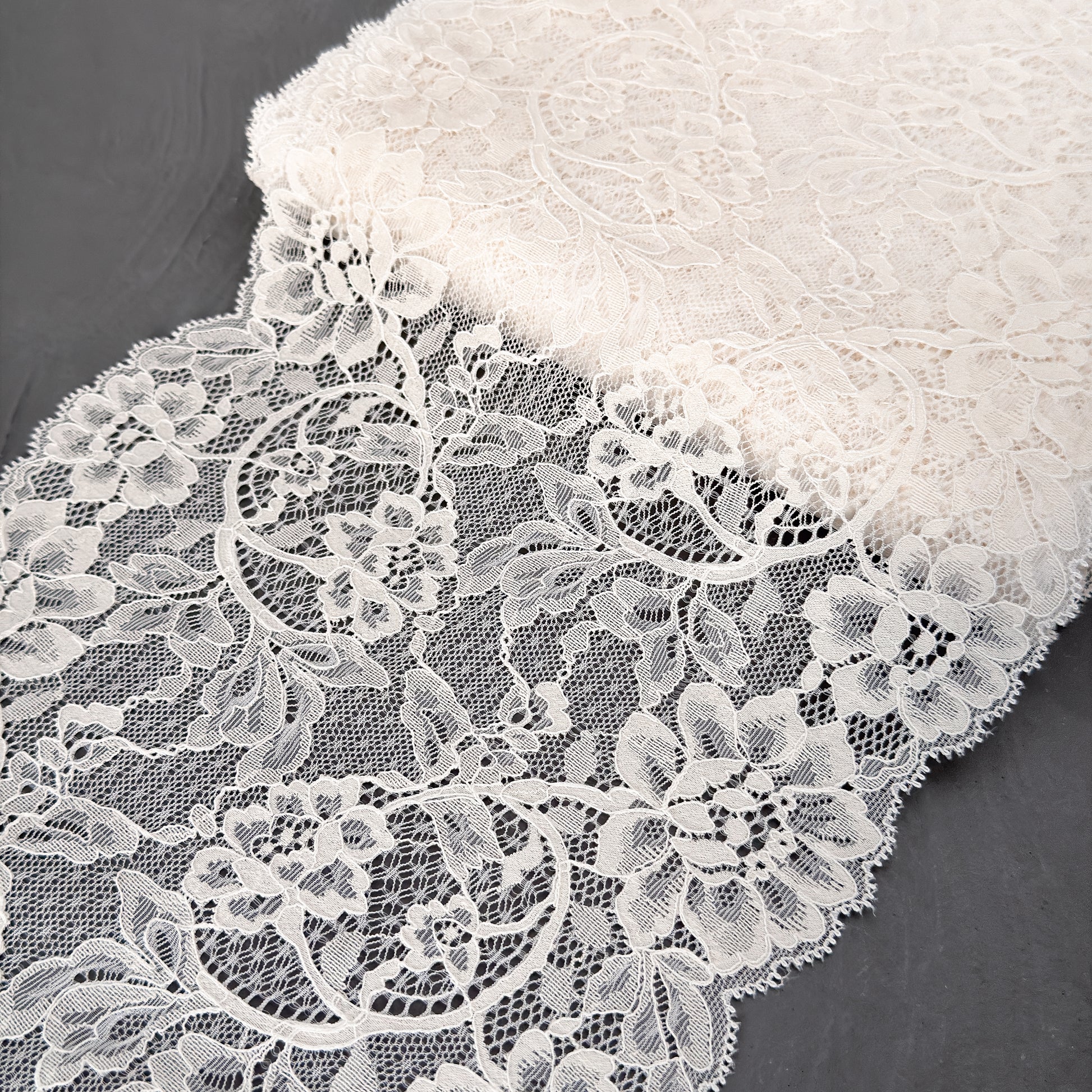 Close-up of white lace fabric on a dark background