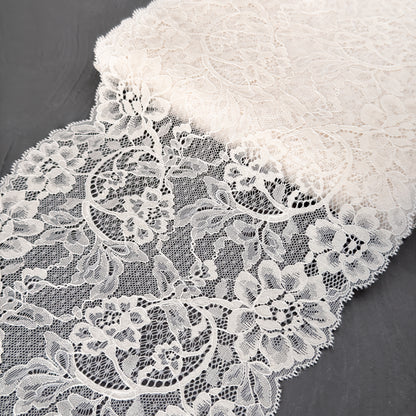 Close-up of white lace fabric on a dark background