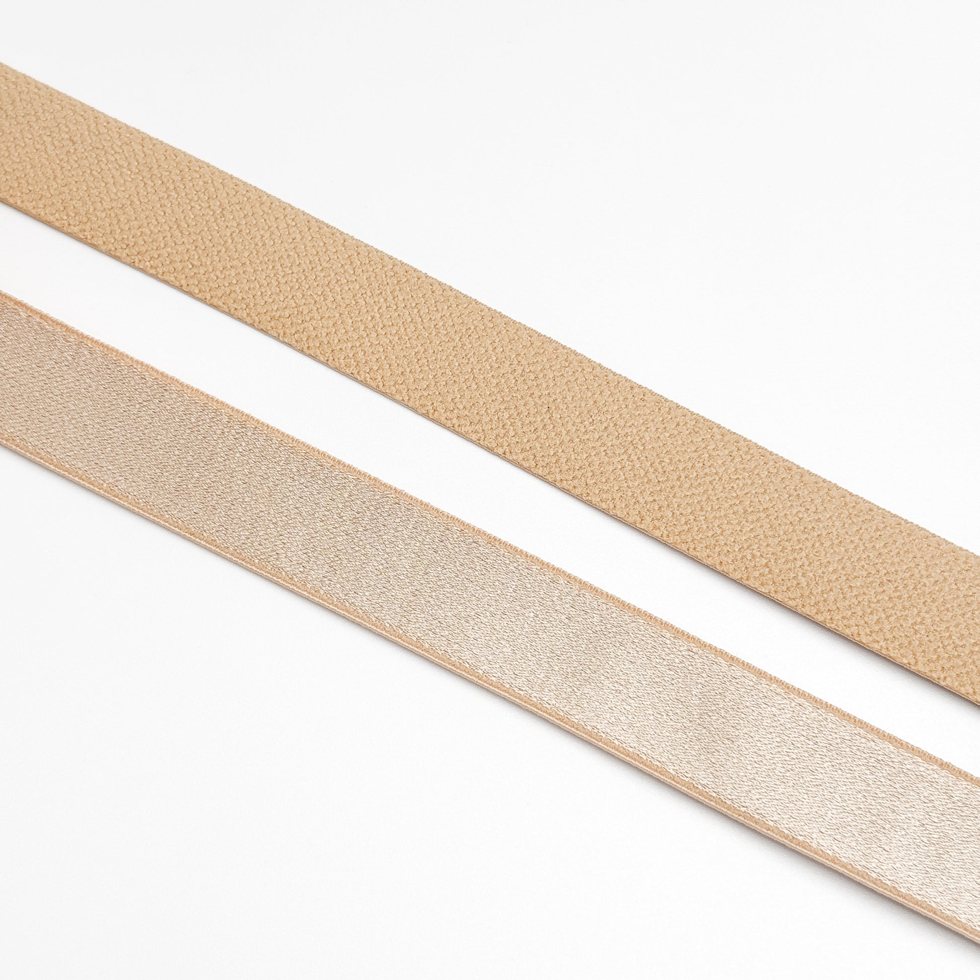 Two beige straps on a white background