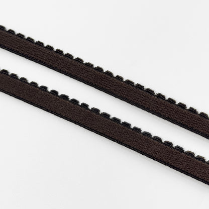 Two brown plush elastics with a zigzag edge on a white background