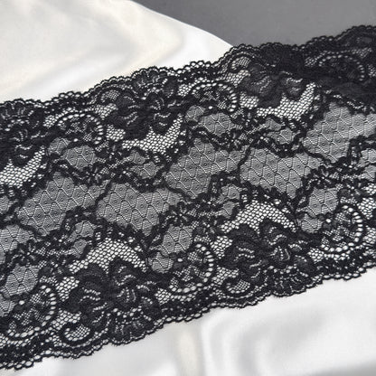 Close-up of black lace fabric on a white background