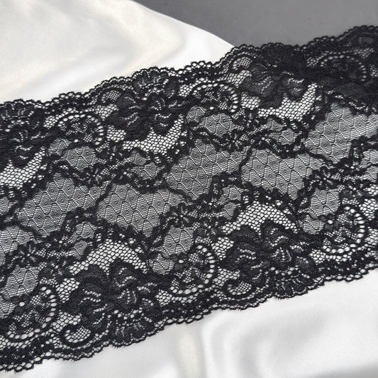 Close-up of black lace fabric on a white background