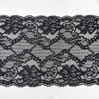 Black lace fabric on a white background