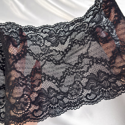 Close-up of black lace fabric on a white background