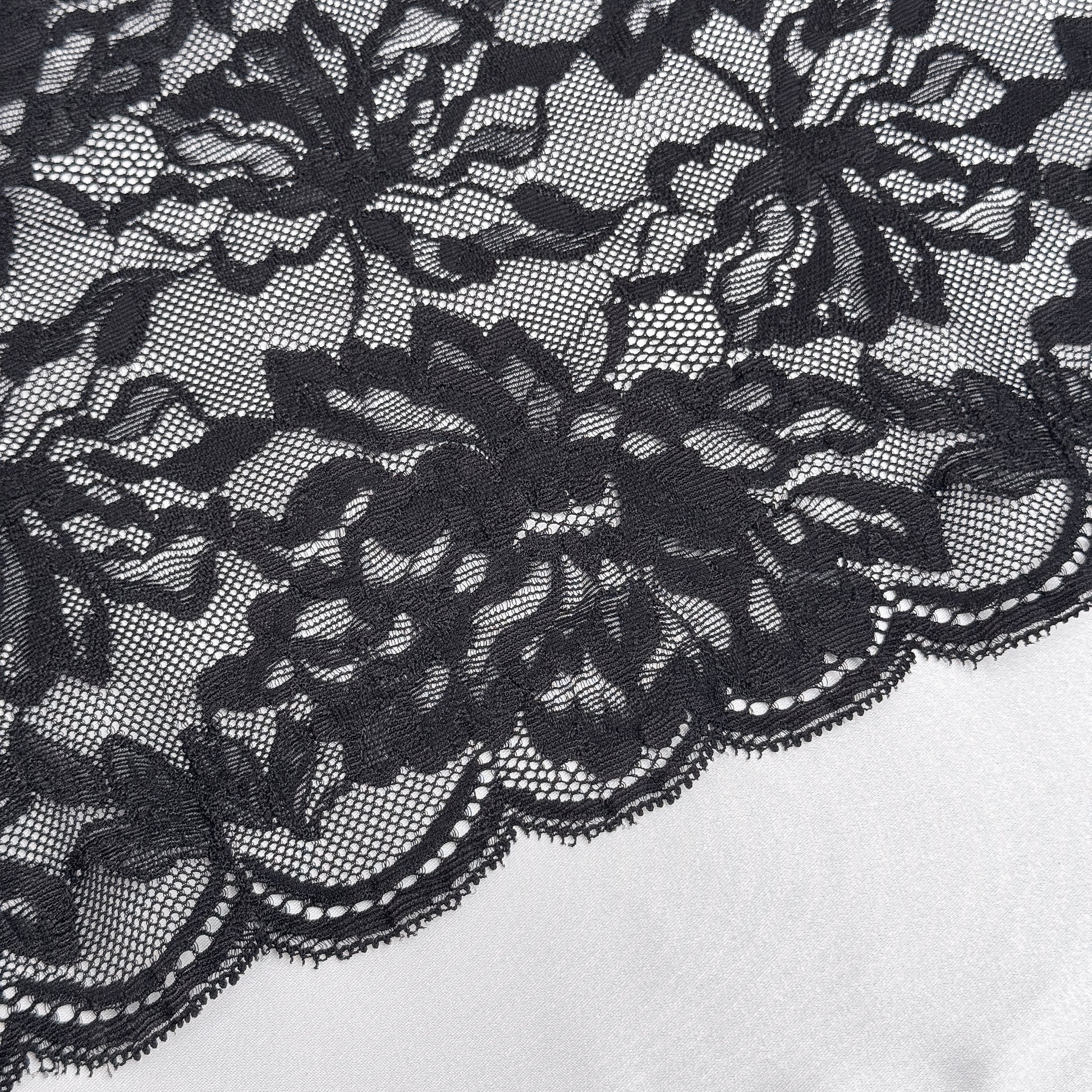 Close-up of black lace fabric on a white background