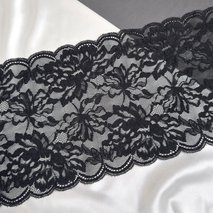 Black lace fabric on a white satin background