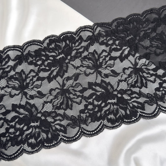 Black lace fabric on a white satin background