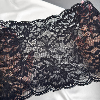 Close-up of black lace fabric on a white background