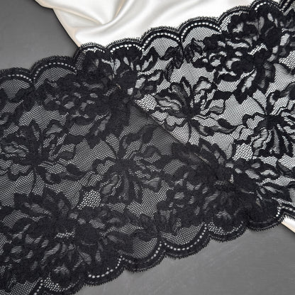 Close-up of black lace fabric on a gray background