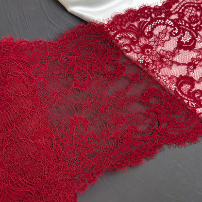 Close-up of red lace fabric on a gray background
