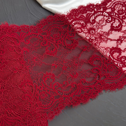 Close-up of red lace fabric on a gray background
