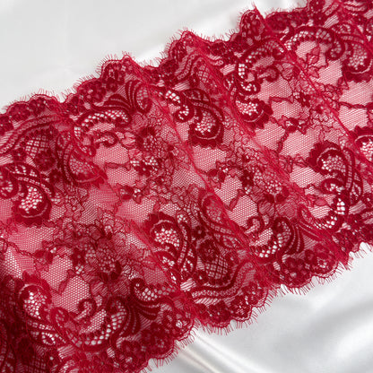 Close-up of red lace fabric on a white background